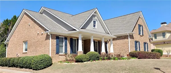 a front view of a house with garden