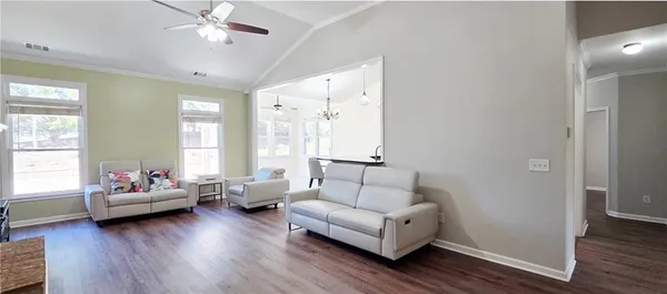 a living room with furniture and wooden floor