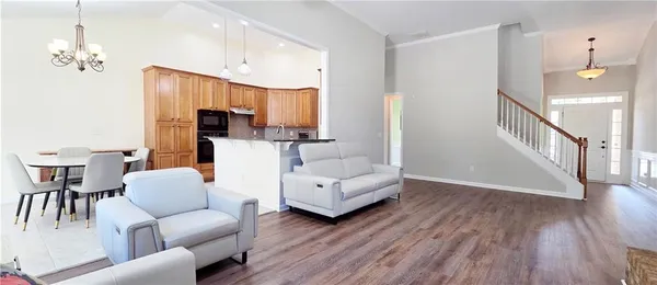 a living room with furniture and a chandelier