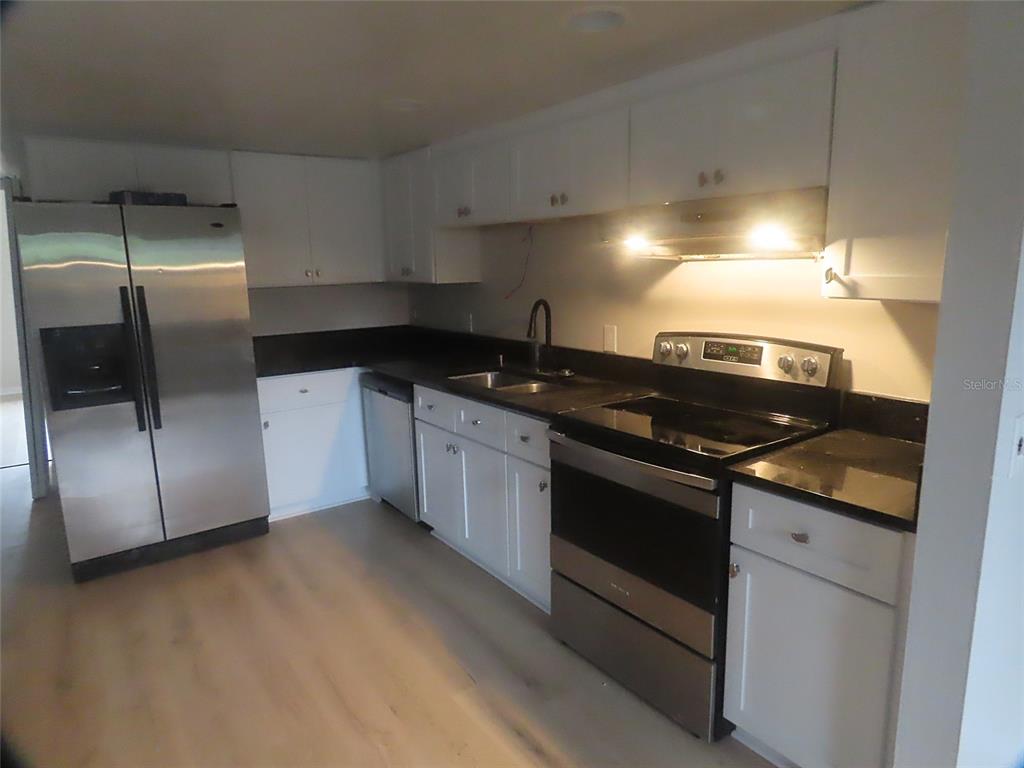 708 St Michael Lane Altamonte Springs, FL 32714 - Photo 5 of 26 a kitchen with stainless steel appliances granite countertop a sink and a stove