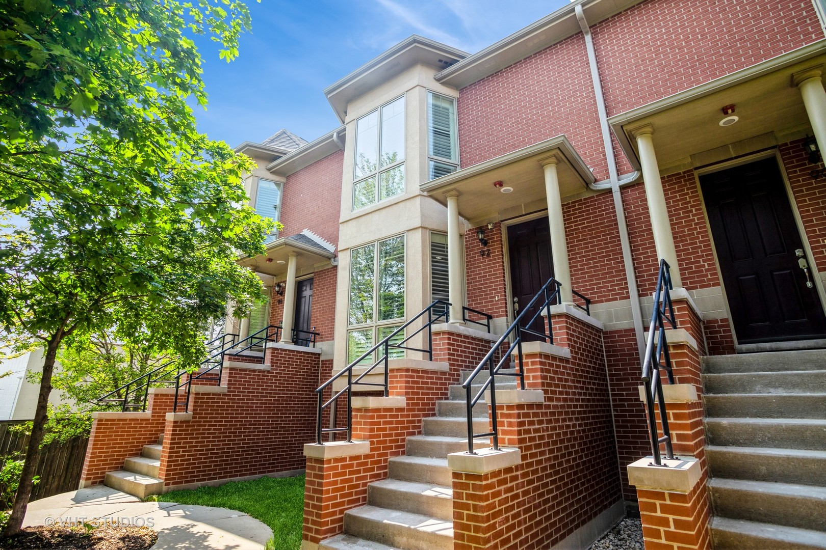 a view of a patio with couches table and chairs and potted plants