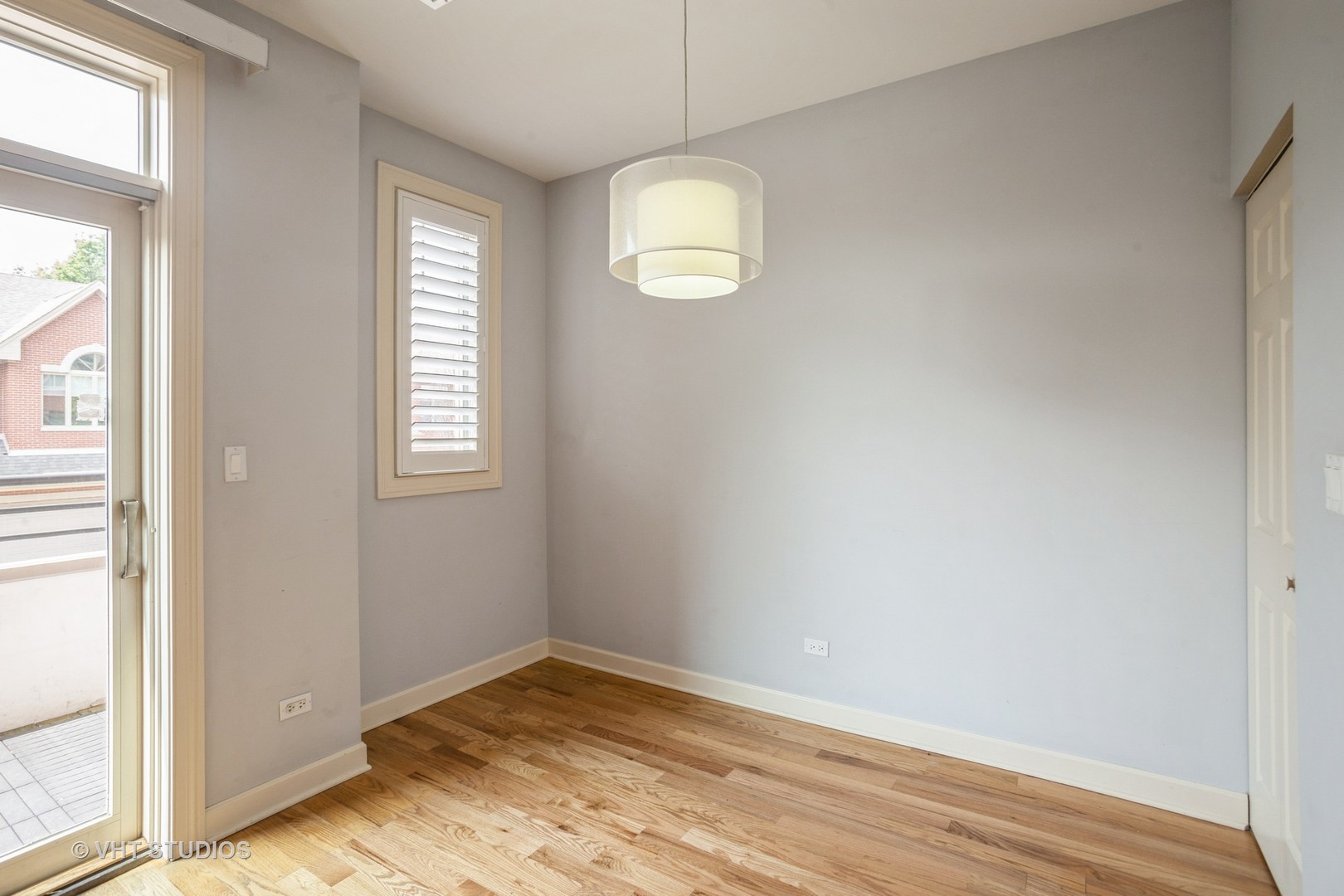 92 Legacy Lane Wheeling, IL 60090 - Photo 23 of 28 an empty room with wooden floor and windows