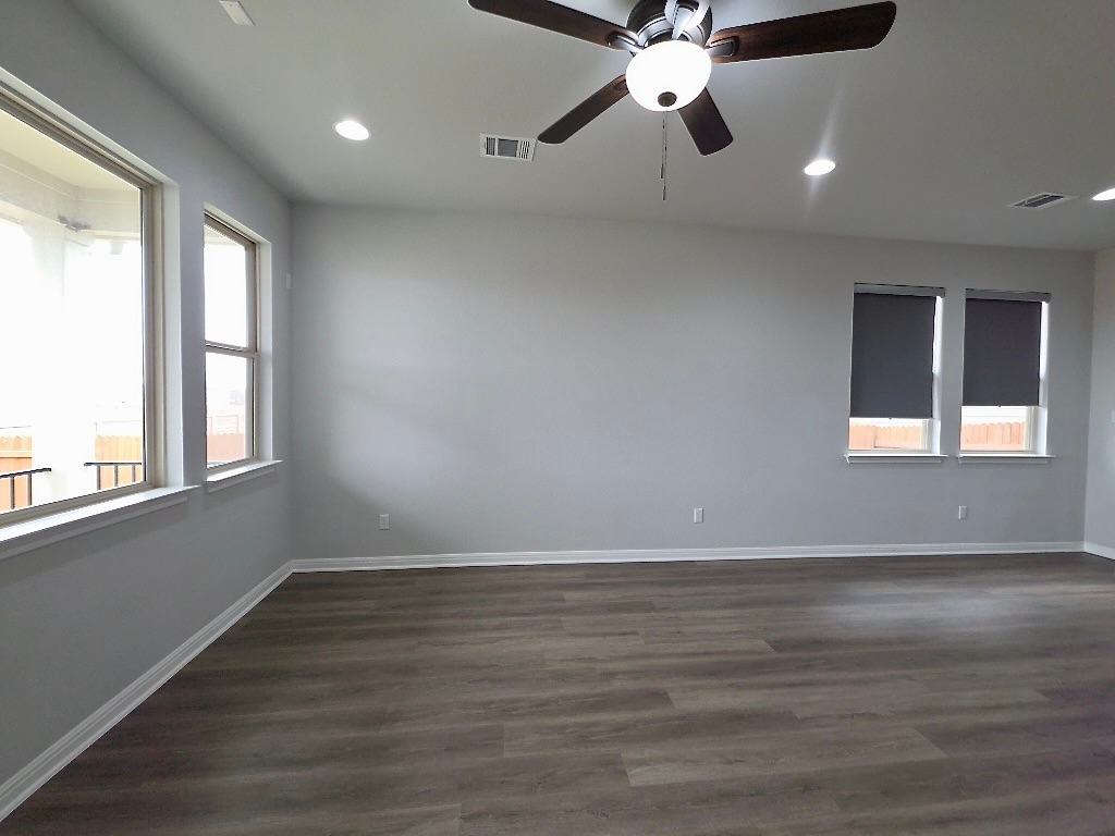 533 Rearing Mare Pass Georgetown, TX 78626 - Photo 11 of 22 an empty room with wooden floor fan and windows