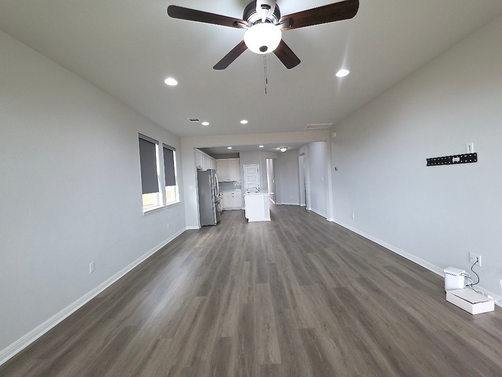 533 Rearing Mare Pass Georgetown, TX 78626 - Photo 9 of 22 a view of empty room with wooden floor and fan
