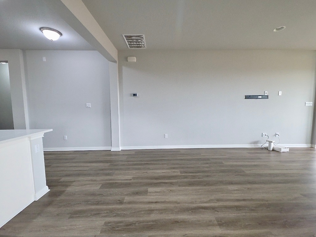 533 Rearing Mare Pass Georgetown, TX 78626 - Photo 10 of 22 a view of an empty room with wooden floor