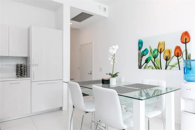 a kitchen with stainless steel appliances granite countertop a sink dishwasher a stove and white cabinets with wooden floor