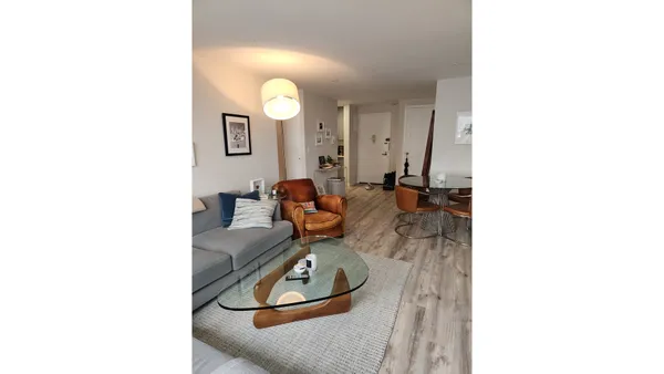 a living room with furniture and a mirror