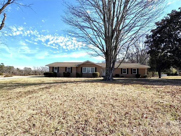 a large tree in front of a house