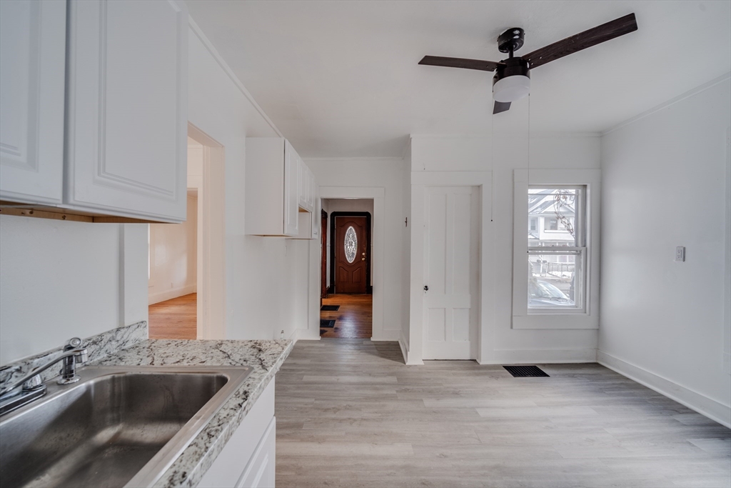 50 Home Street Springfield, MA 01104 - Photo 11 of 18 a kitchen with a sink a refrigerator and cabinets