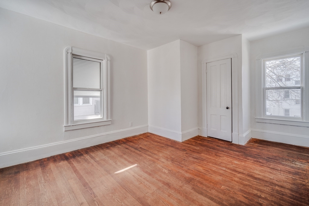 50 Home Street Springfield, MA 01104 - Photo 12 of 18 wooden floor in an empty room with a window