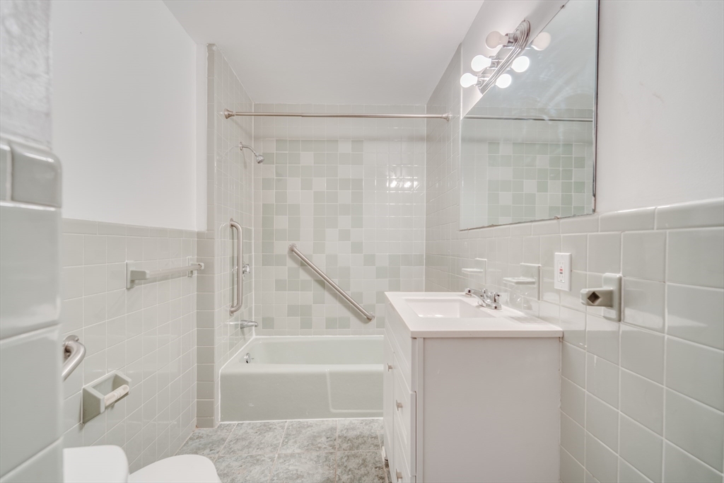 50 Home Street Springfield, MA 01104 - Photo 15 of 18 a bathroom with a sink a toilet and shower