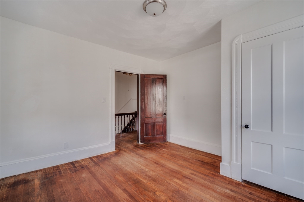 50 Home Street Springfield, MA 01104 - Photo 17 of 18 a view of an empty room with wooden floor and closet