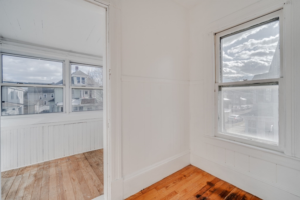 50 Home Street Springfield, MA 01104 - Photo 3 of 18 a view of a bedroom with wooden floor and cabinet