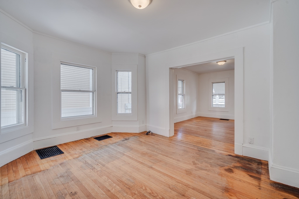 50 Home Street Springfield, MA 01104 - Photo 6 of 18 an empty room with wooden floor and windows