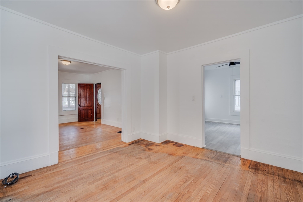 50 Home Street Springfield, MA 01104 - Photo 7 of 18 a view of empty room with wooden floor and kitchen