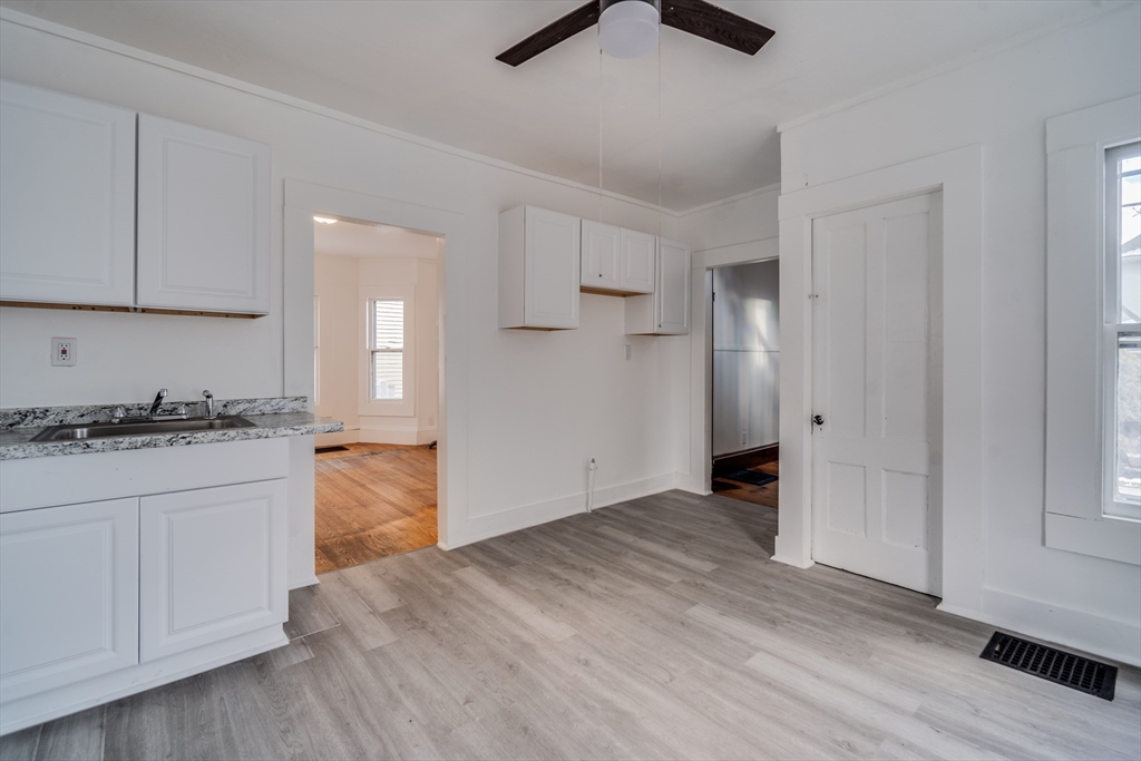 50 Home Street Springfield, MA 01104 - Photo 10 of 18 a view of a kitchen with wooden floor