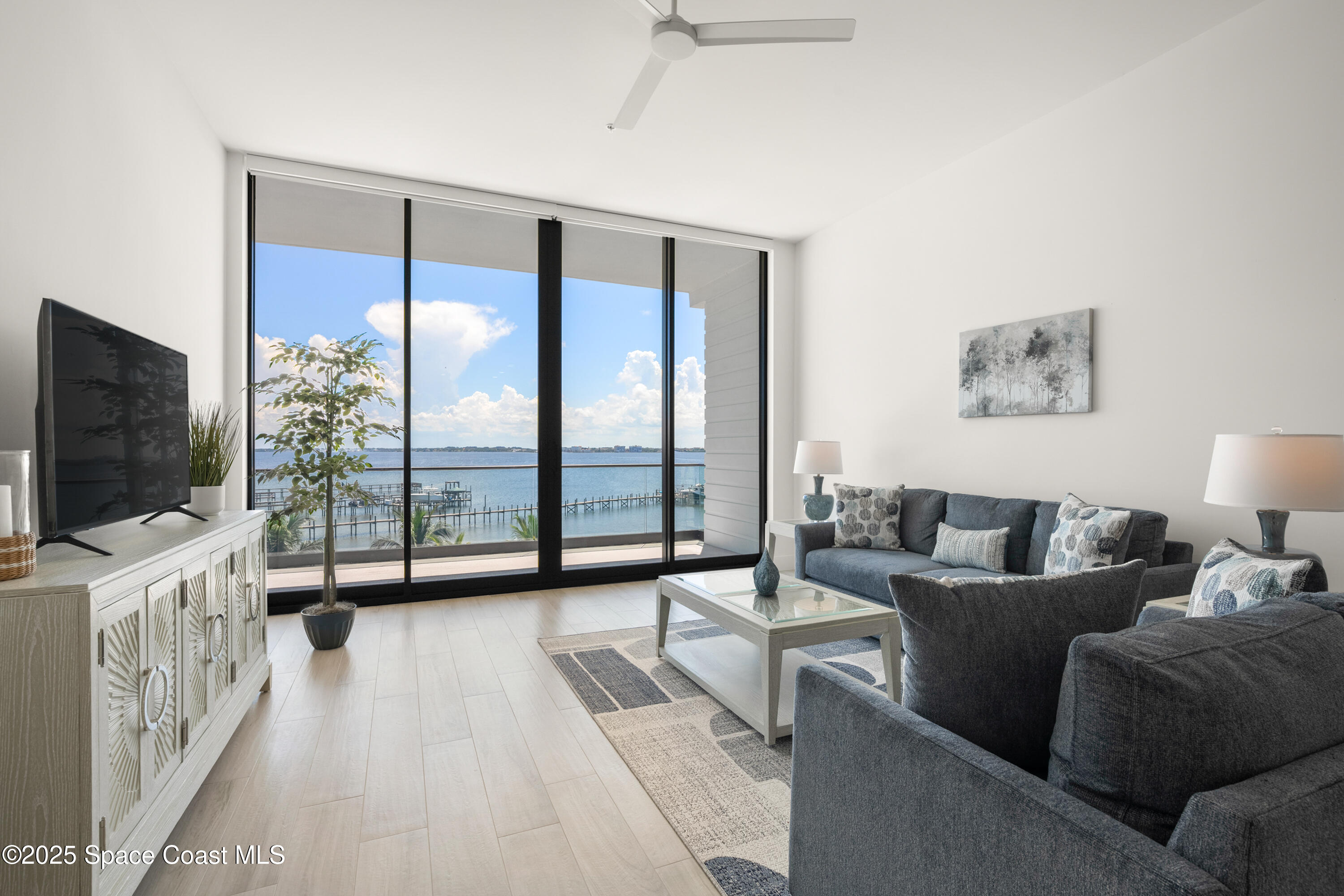 225 Strand Drive, Unit 406 Melbourne Beach, FL 32951 - Photo 11 of 49 a living room with furniture and a flat screen tv