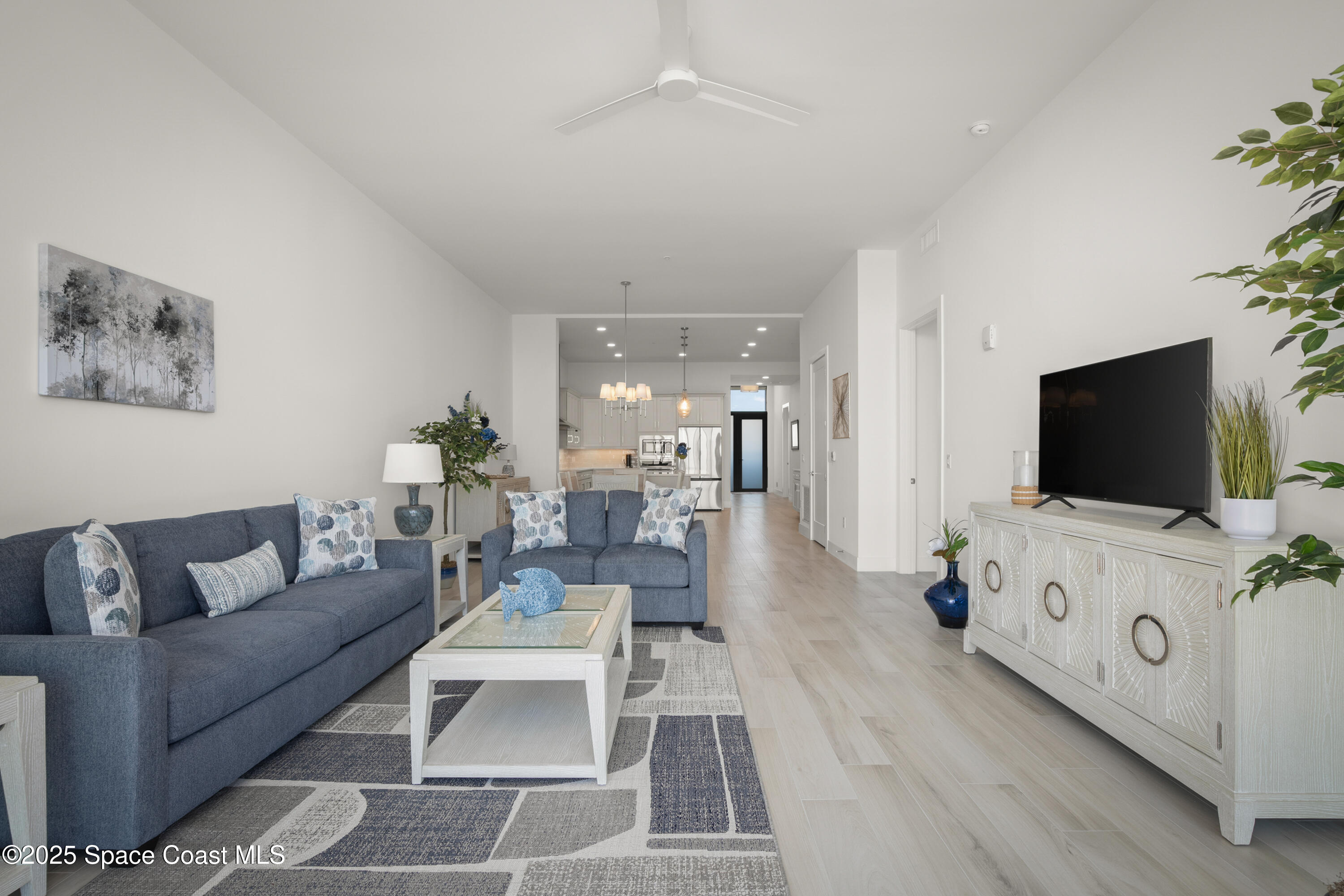 225 Strand Drive, Unit 406 Melbourne Beach, FL 32951 - Photo 13 of 49 a living room with furniture and a flat screen tv