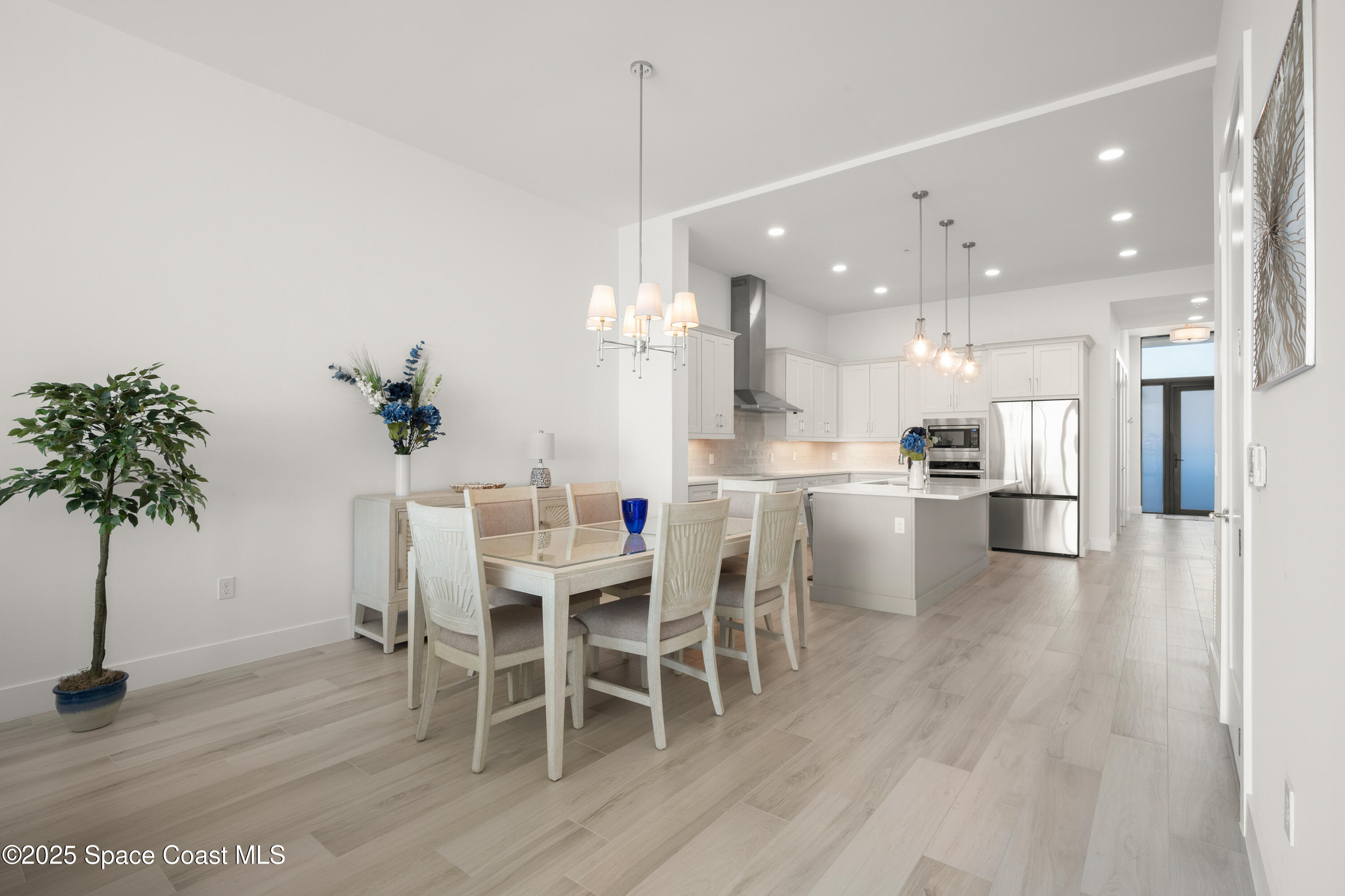 225 Strand Drive, Unit 406 Melbourne Beach, FL 32951 - Photo 15 of 49 a dining room with furniture and a kitchen view