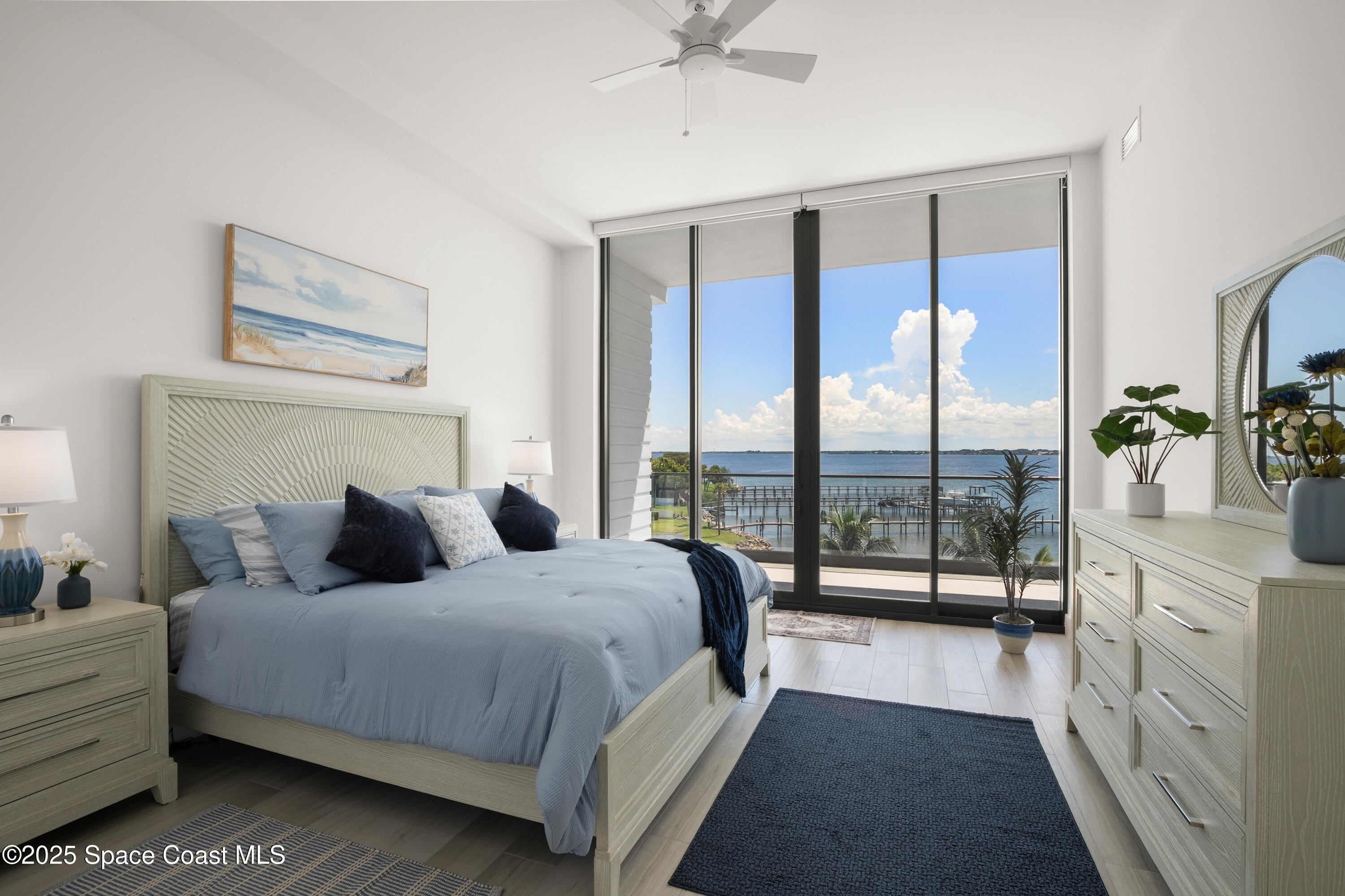 225 Strand Drive, Unit 406 Melbourne Beach, FL 32951 - Photo 20 of 49 a bedroom with a large bed and a balcony view