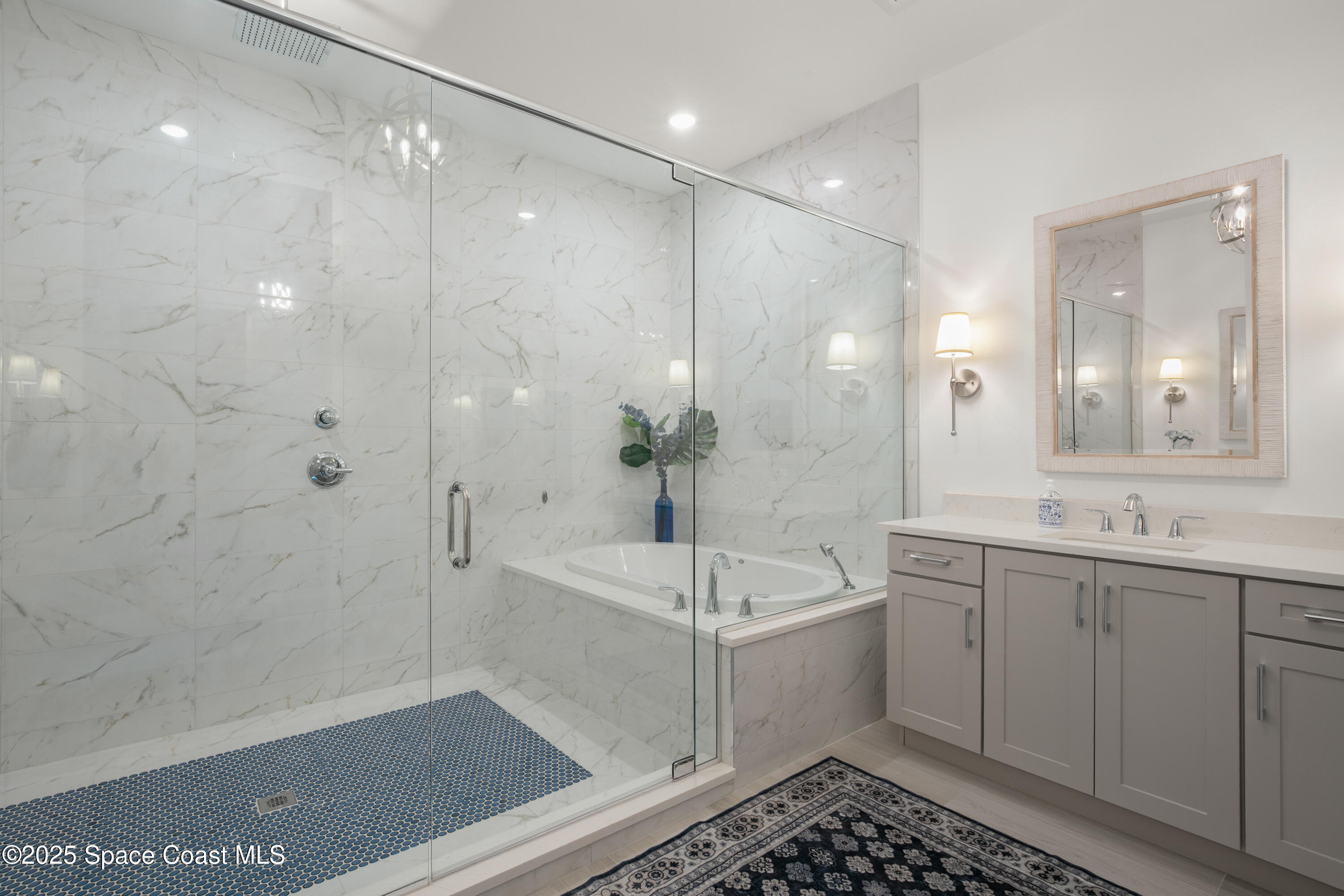225 Strand Drive, Unit 406 Melbourne Beach, FL 32951 - Photo 22 of 49 a bathroom with a bathtub a sink and a shower
