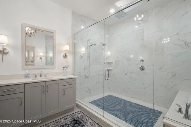 a bathroom with a shower sink and mirror