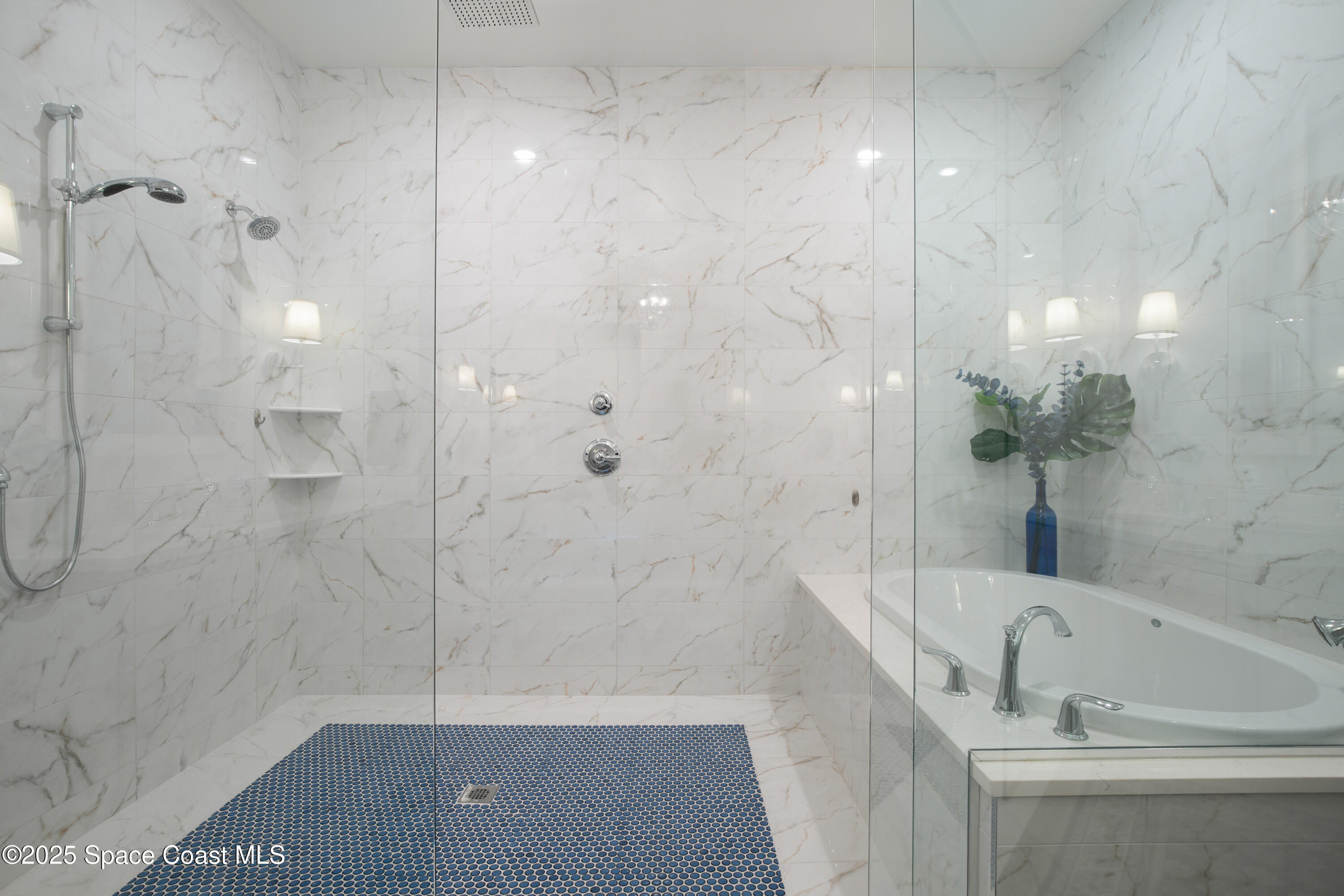 225 Strand Drive, Unit 406 Melbourne Beach, FL 32951 - Photo 24 of 49 a bathroom with a bathtub and a shower