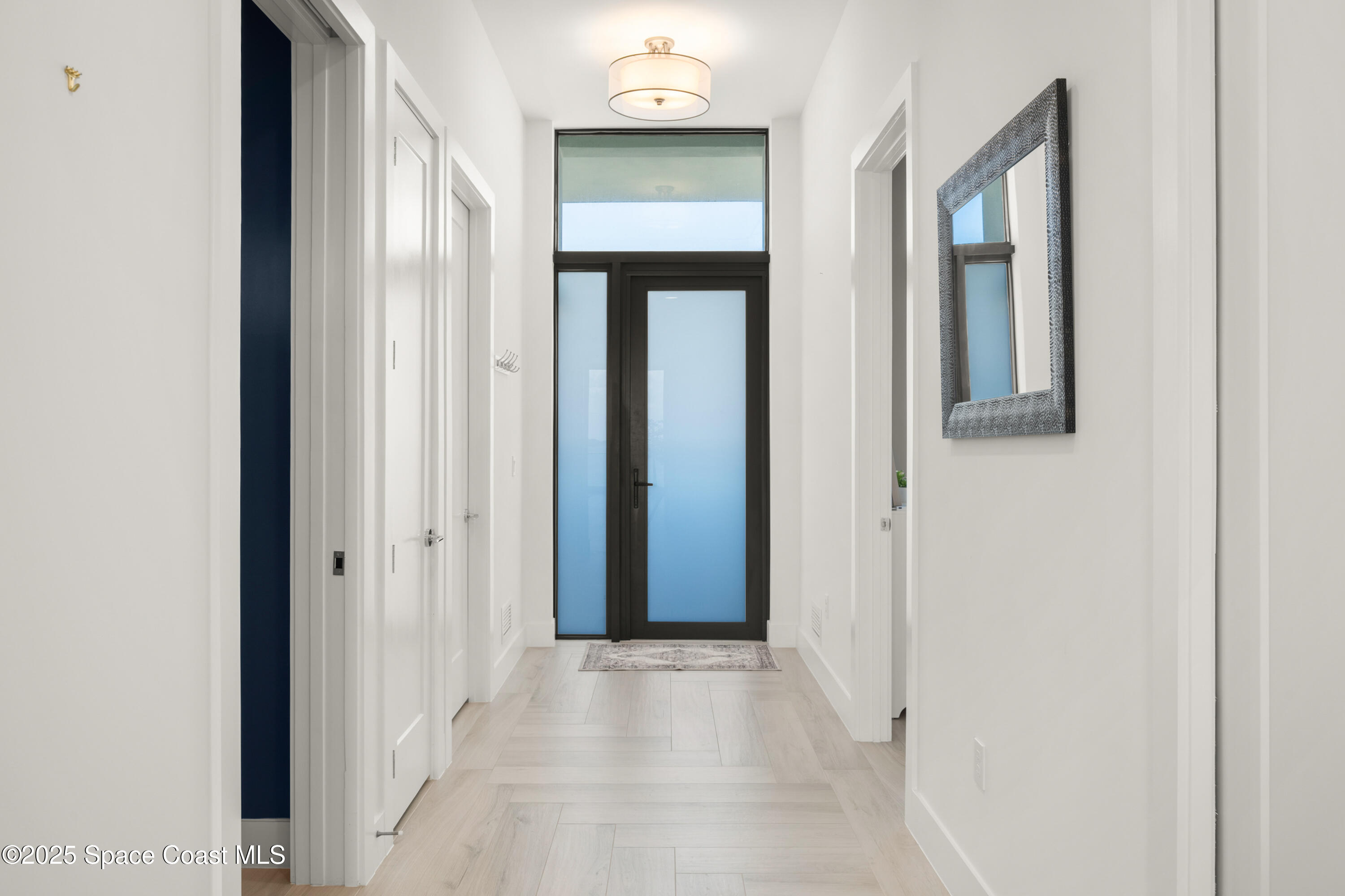 225 Strand Drive, Unit 406 Melbourne Beach, FL 32951 - Photo 28 of 49 a view of a hallway with wooden floor