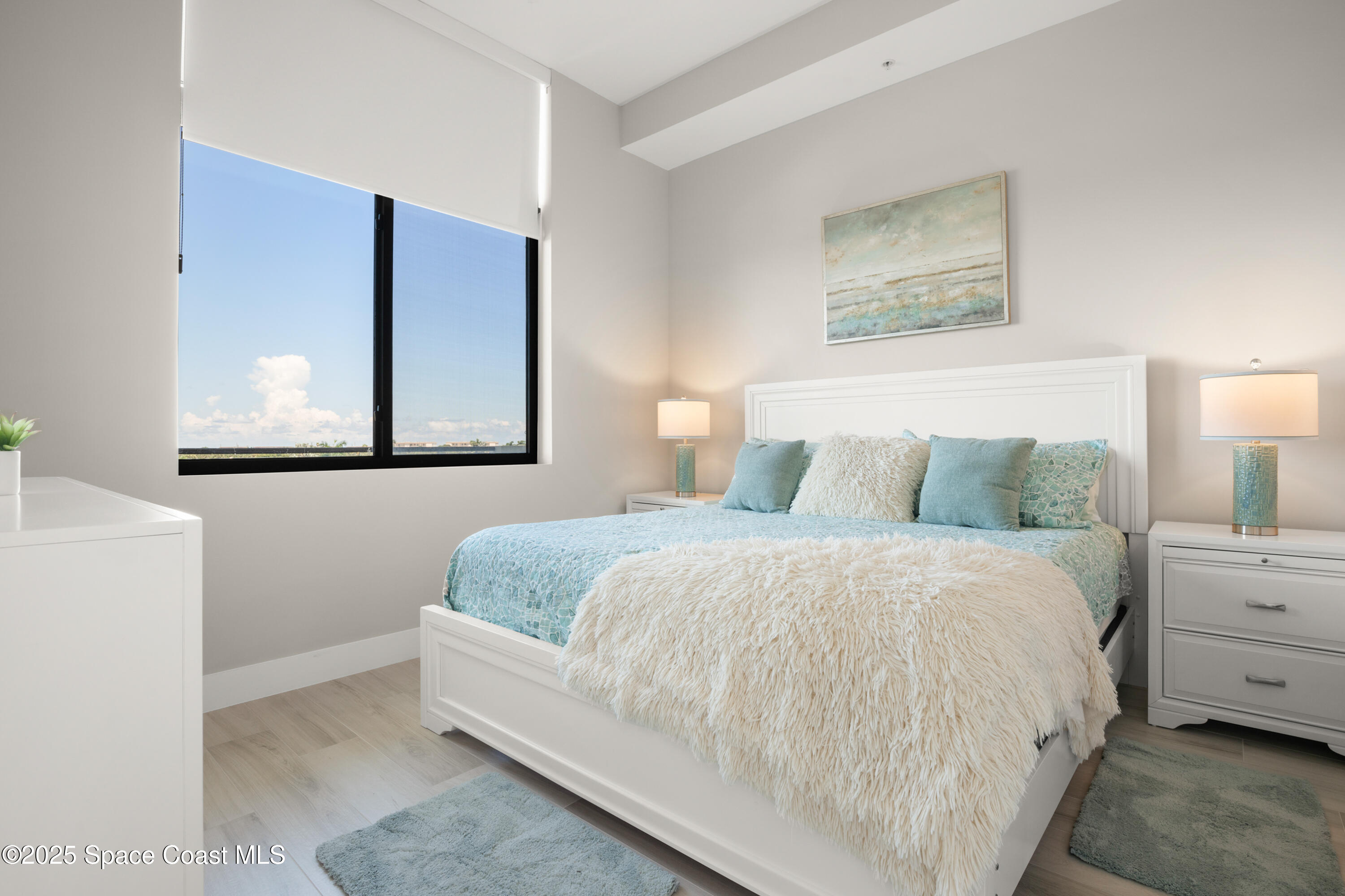 225 Strand Drive, Unit 406 Melbourne Beach, FL 32951 - Photo 30 of 49 a bedroom with a bed and a painting on the wall