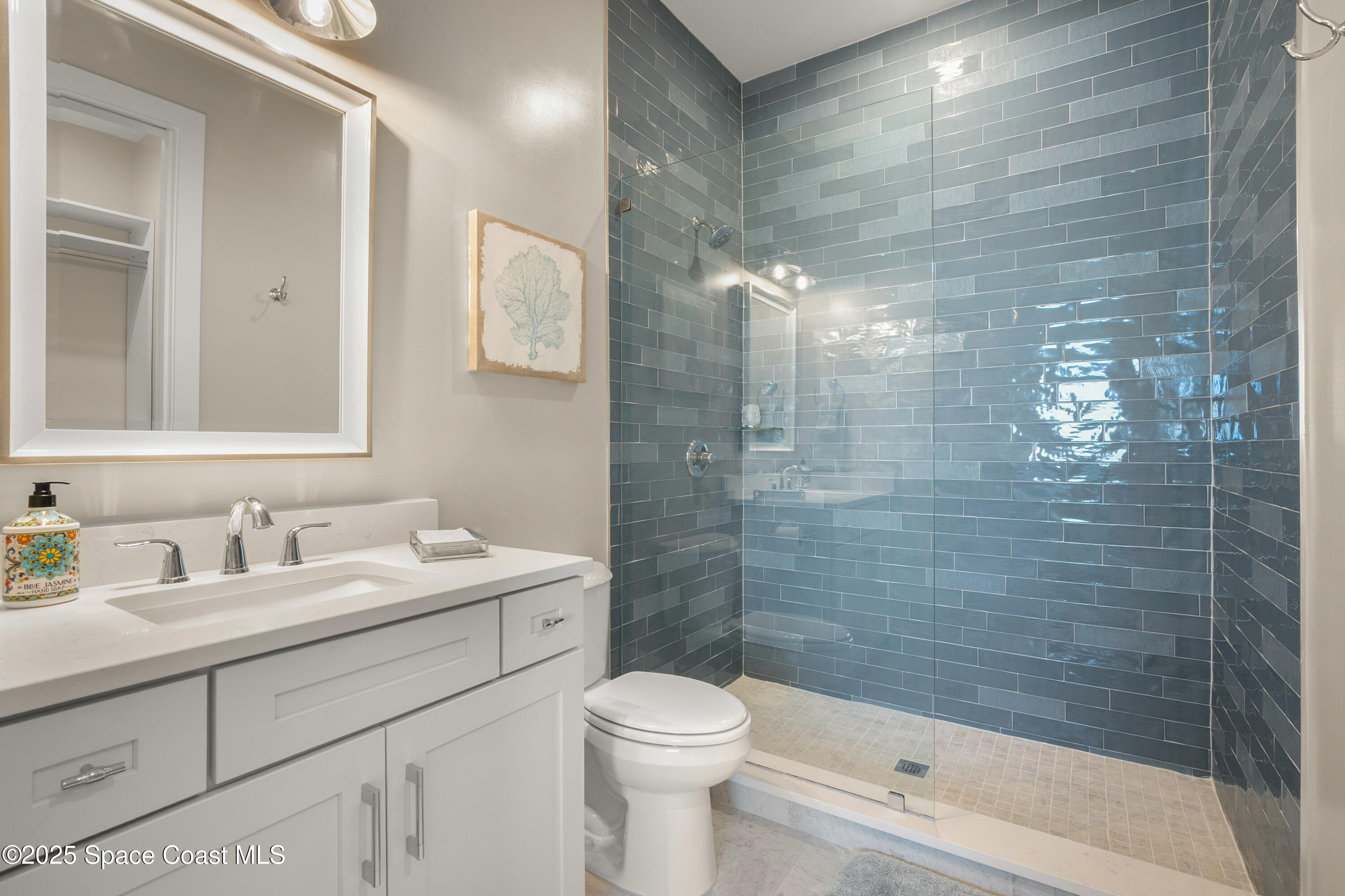 225 Strand Drive, Unit 406 Melbourne Beach, FL 32951 - Photo 31 of 49 a bathroom with a sink a toilet and shower