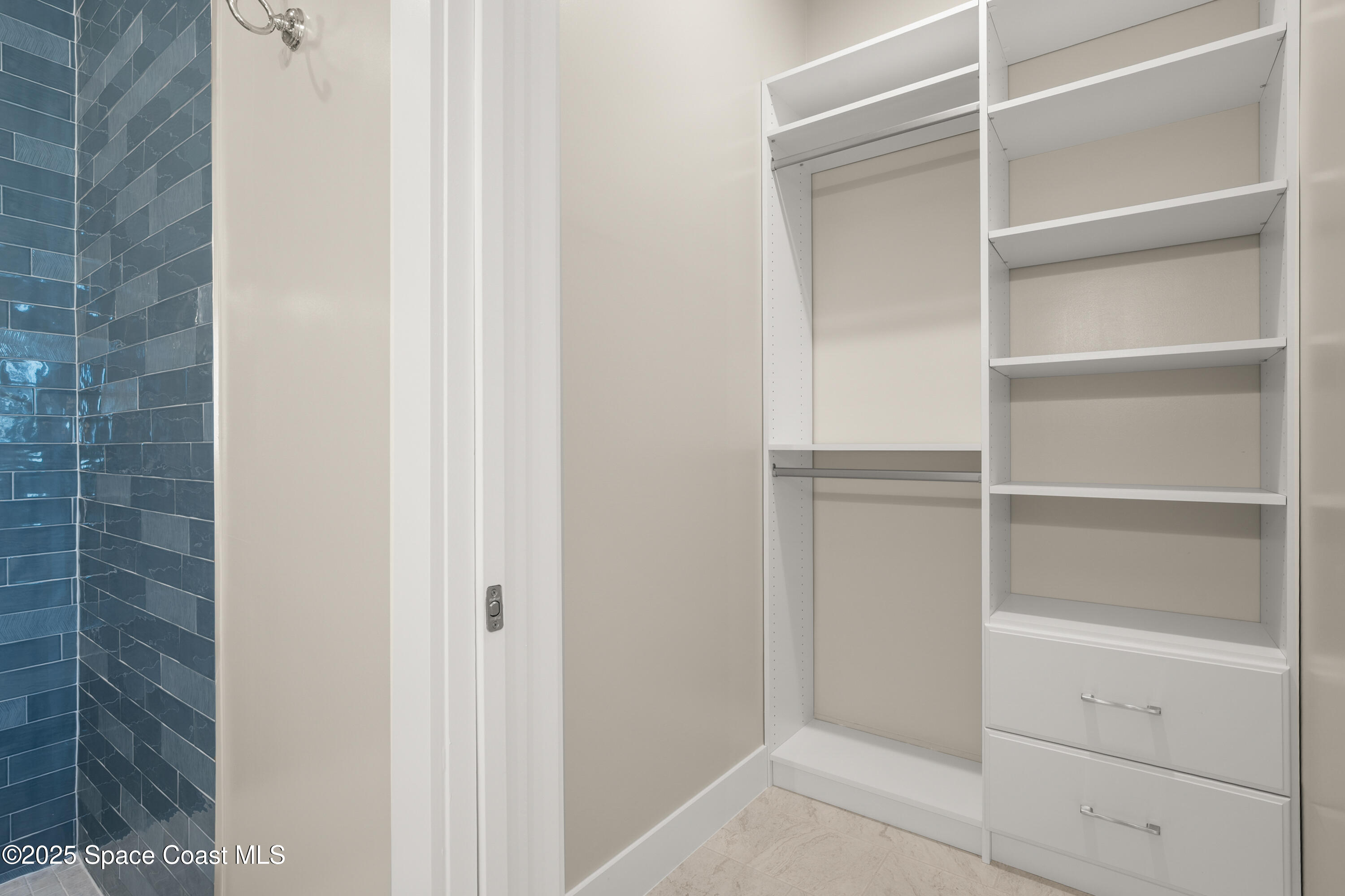 225 Strand Drive, Unit 406 Melbourne Beach, FL 32951 - Photo 32 of 49 a view of walk in closet with empty racks