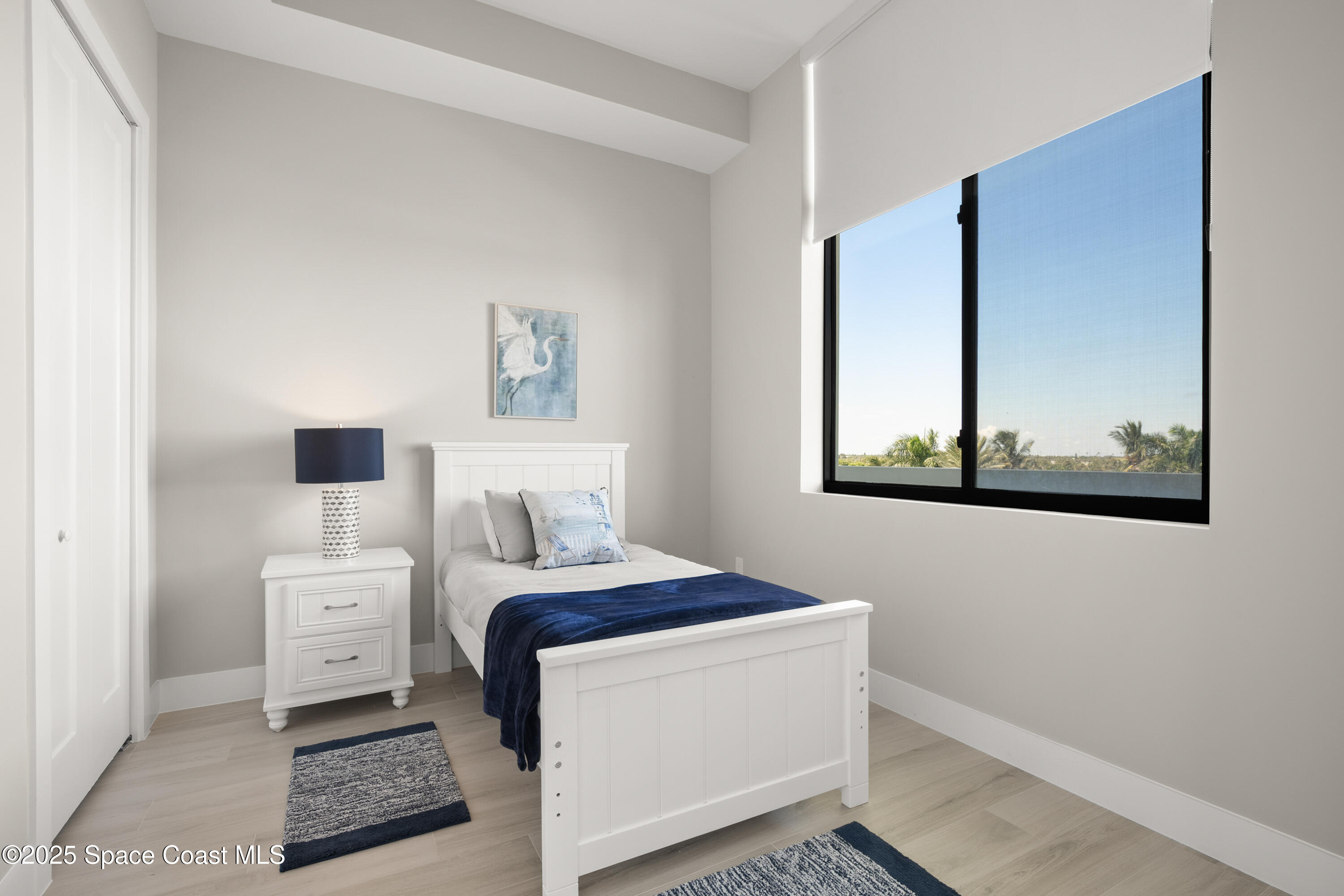 225 Strand Drive, Unit 406 Melbourne Beach, FL 32951 - Photo 34 of 49 a bedroom with a bed and a painting on the wall