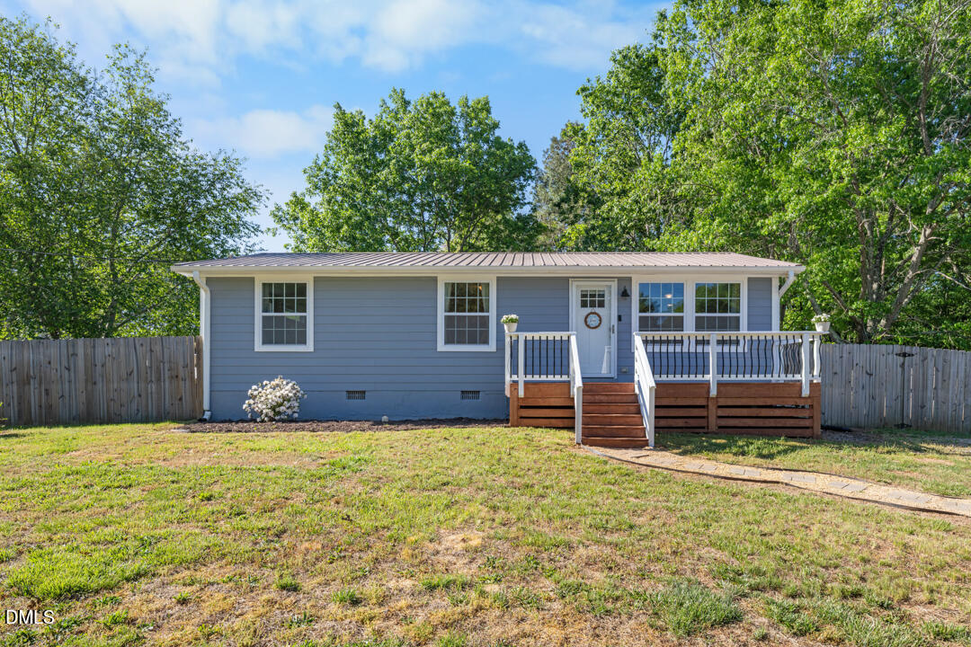 454 Cedar Creek Road Timberlake, NC 27583 - Photo 3 of 39 a view of a house with a yard and wooden fence