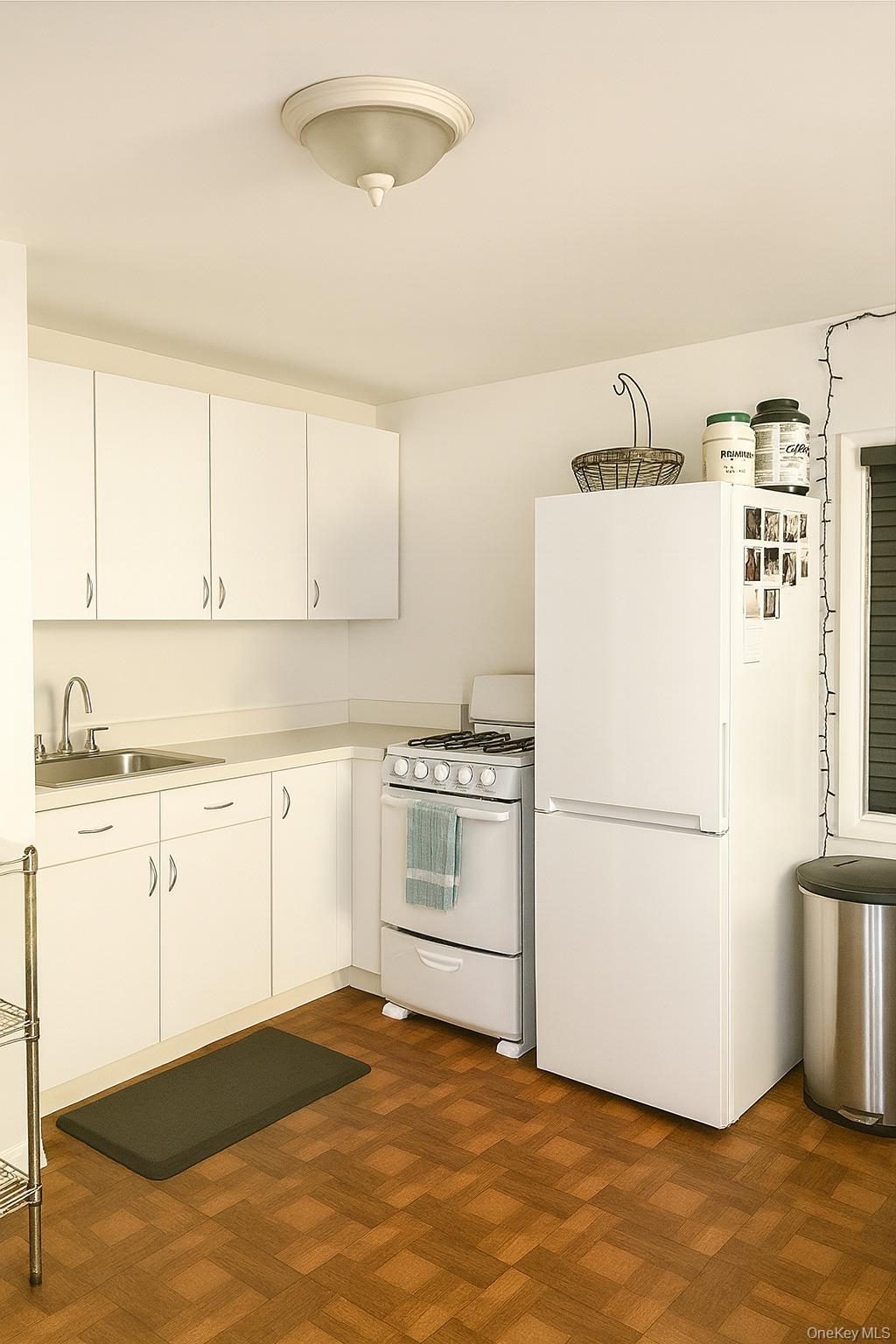 a kitchen with a refrigerator stove and white cabinets