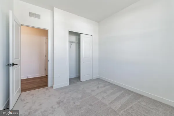 an empty room with closet area
