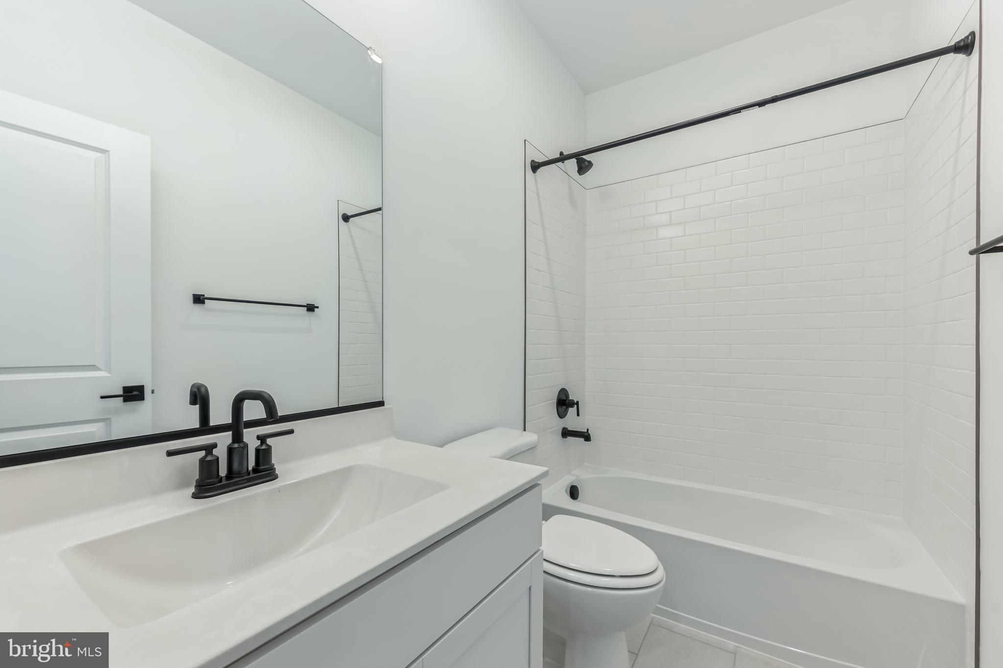 36419 Maple Ridge Lane Georgetown, DE 19947 - Photo 7 of 24 a bathroom with a sink a toilet and a mirror