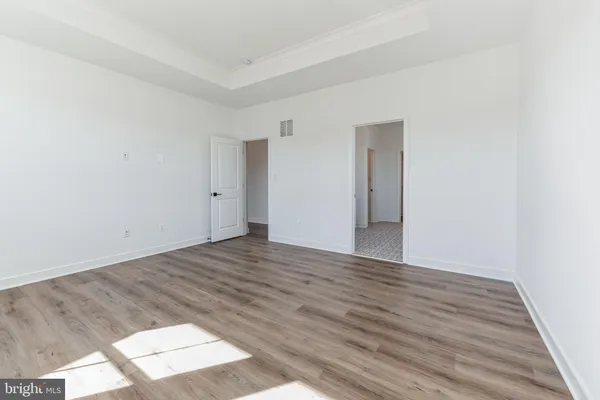 a view of an empty room and wooden floor