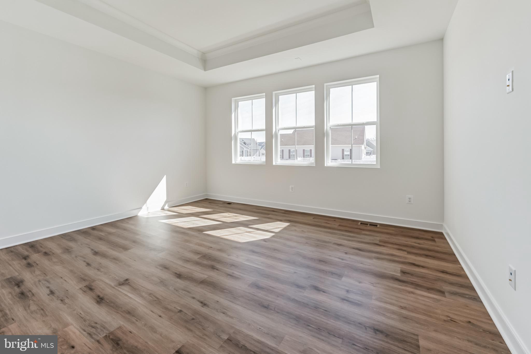 36419 Maple Ridge Lane Georgetown, DE 19947 - Photo 9 of 24 an empty room with wooden floor and windows