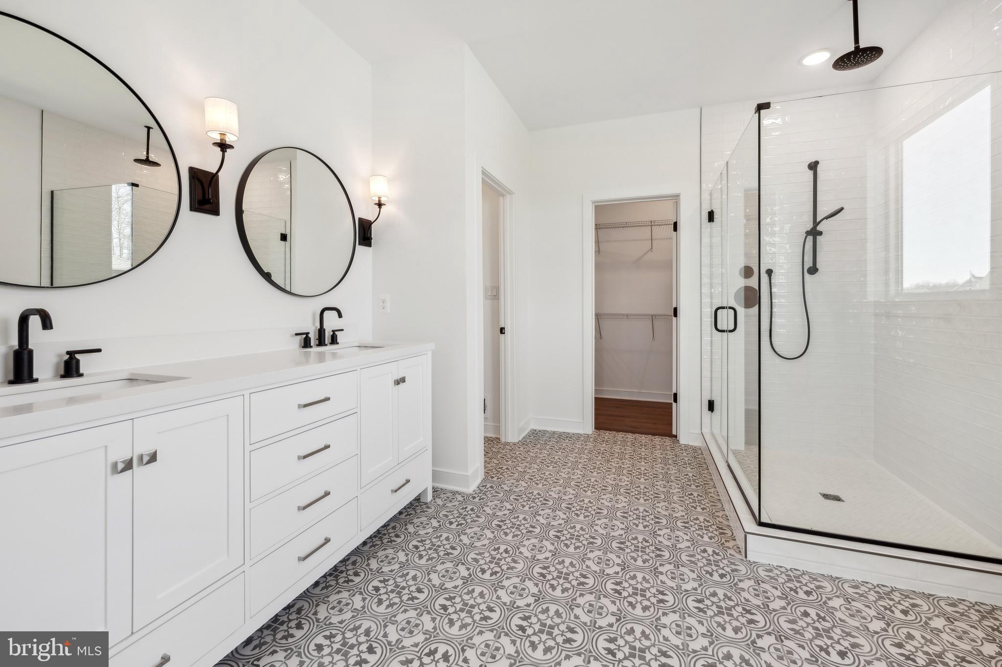 36419 Maple Ridge Lane Georgetown, DE 19947 - Photo 10 of 24 a spacious bathroom with a double vanity sink a mirror a shower and a mirror