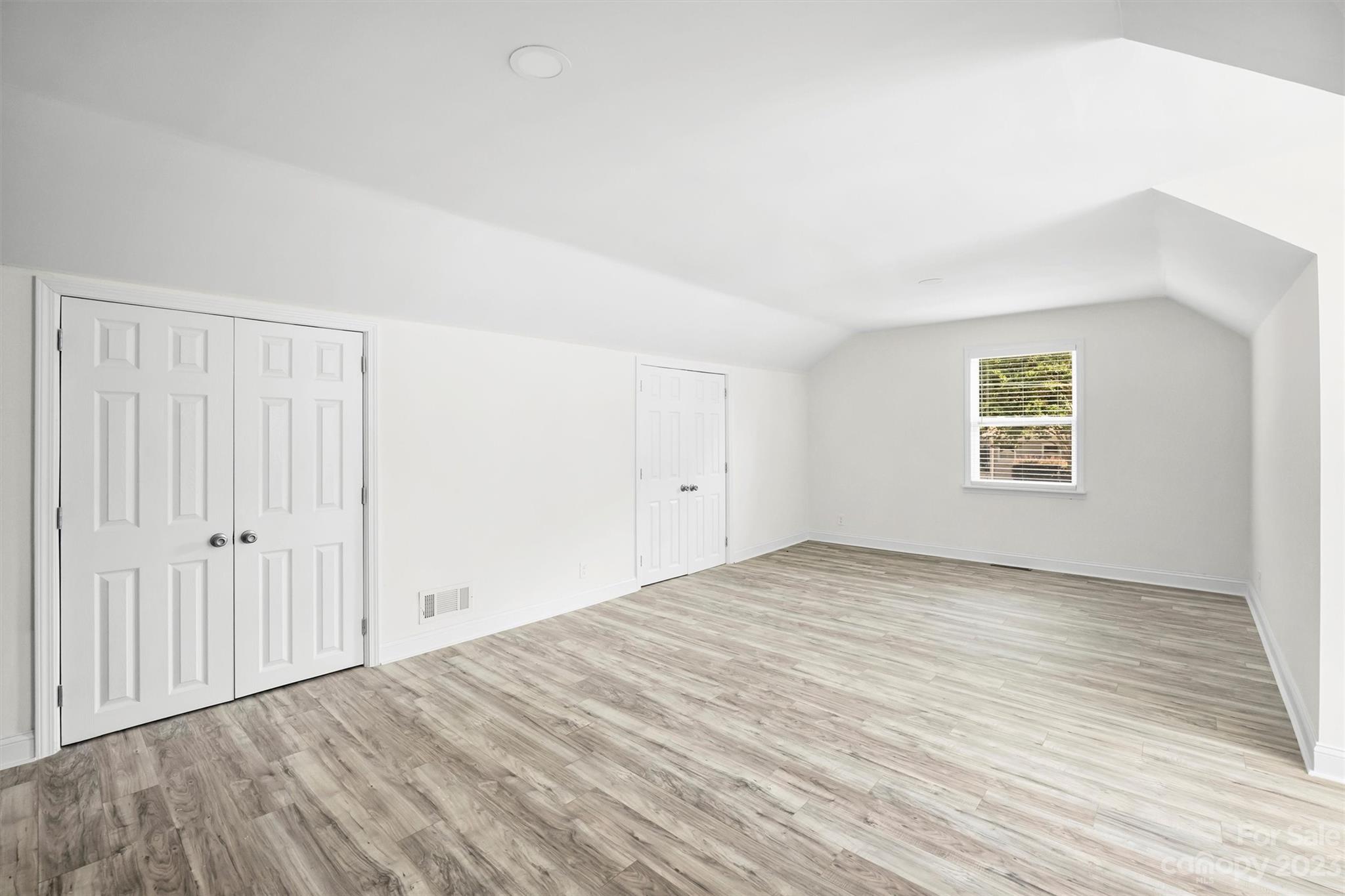 3900 Rhodes Avenue Charlotte, NC 28210 - Photo 15 of 23 a view of an empty room with wooden floor and a window