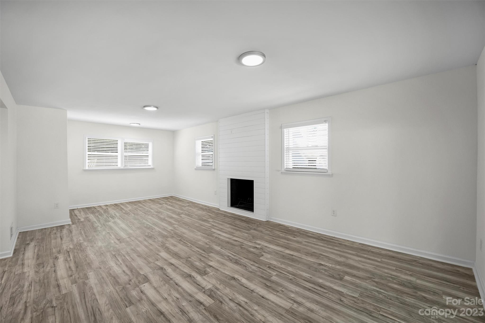 3900 Rhodes Avenue Charlotte, NC 28210 - Photo 19 of 23 a view of empty room with wooden floor and fan