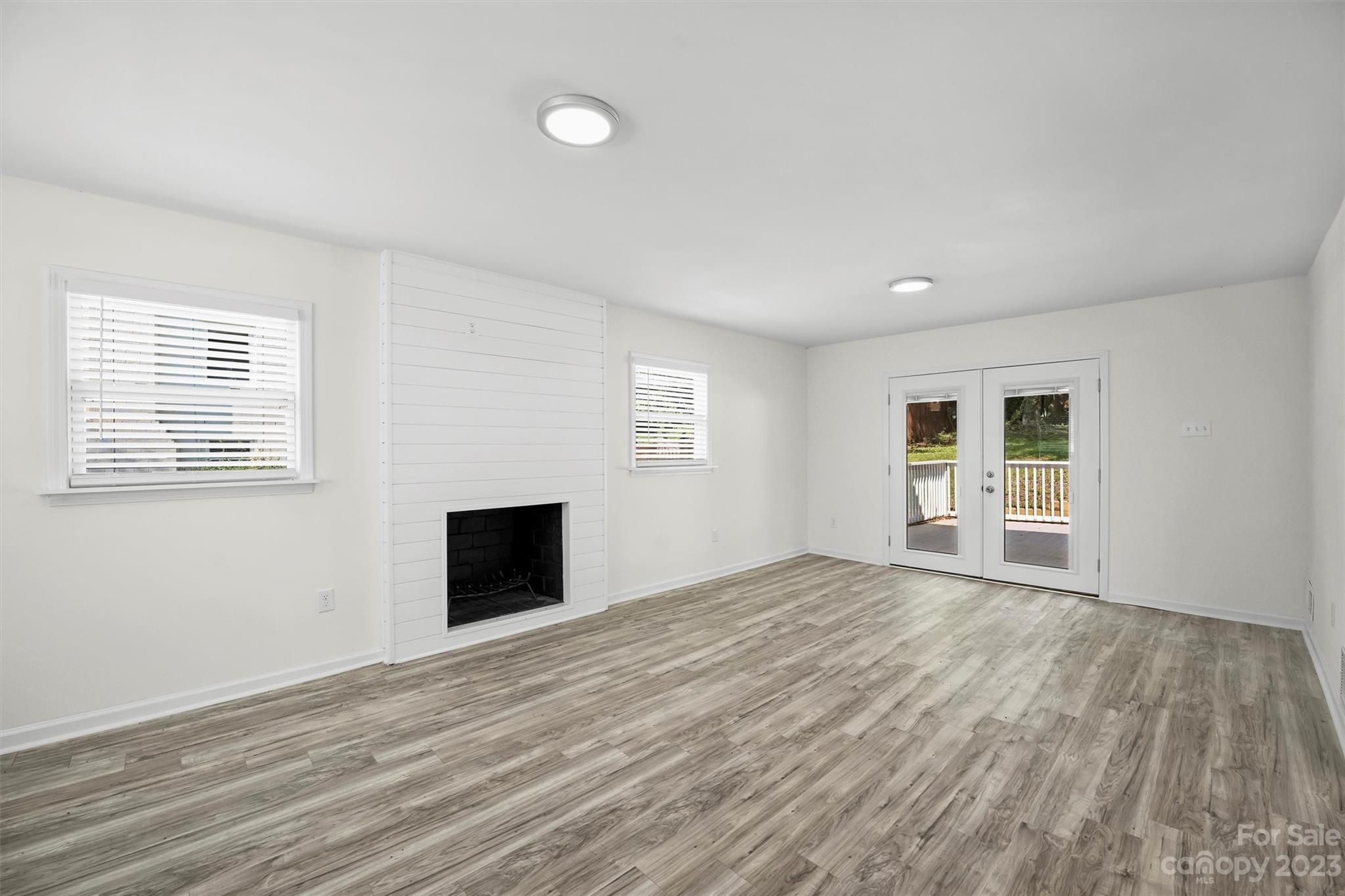 3900 Rhodes Avenue Charlotte, NC 28210 - Photo 20 of 23 a view of empty room with wooden floor and fireplace
