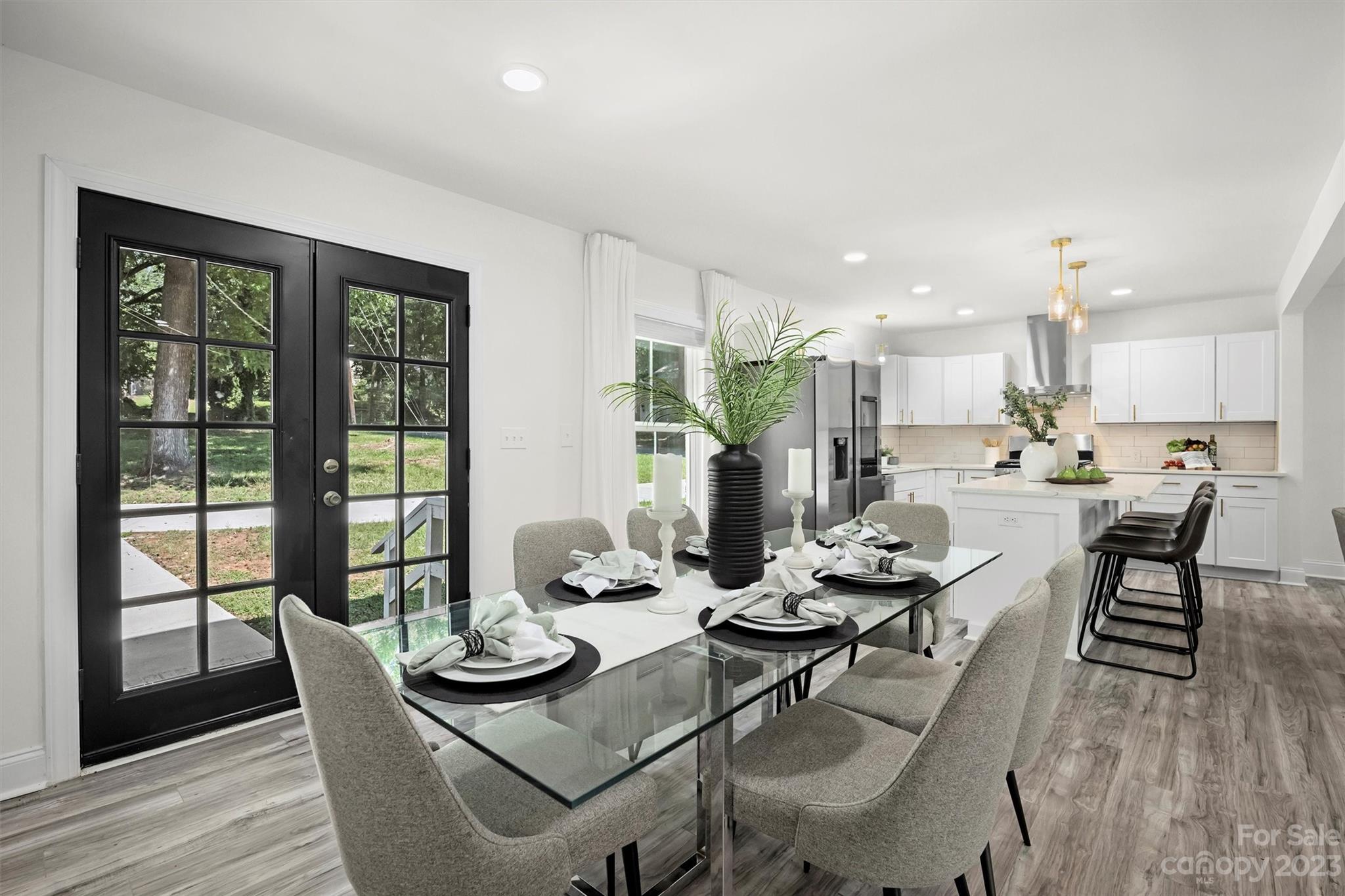 3900 Rhodes Avenue Charlotte, NC 28210 - Photo 7 of 23 a dining room with furniture a large window and wooden floor