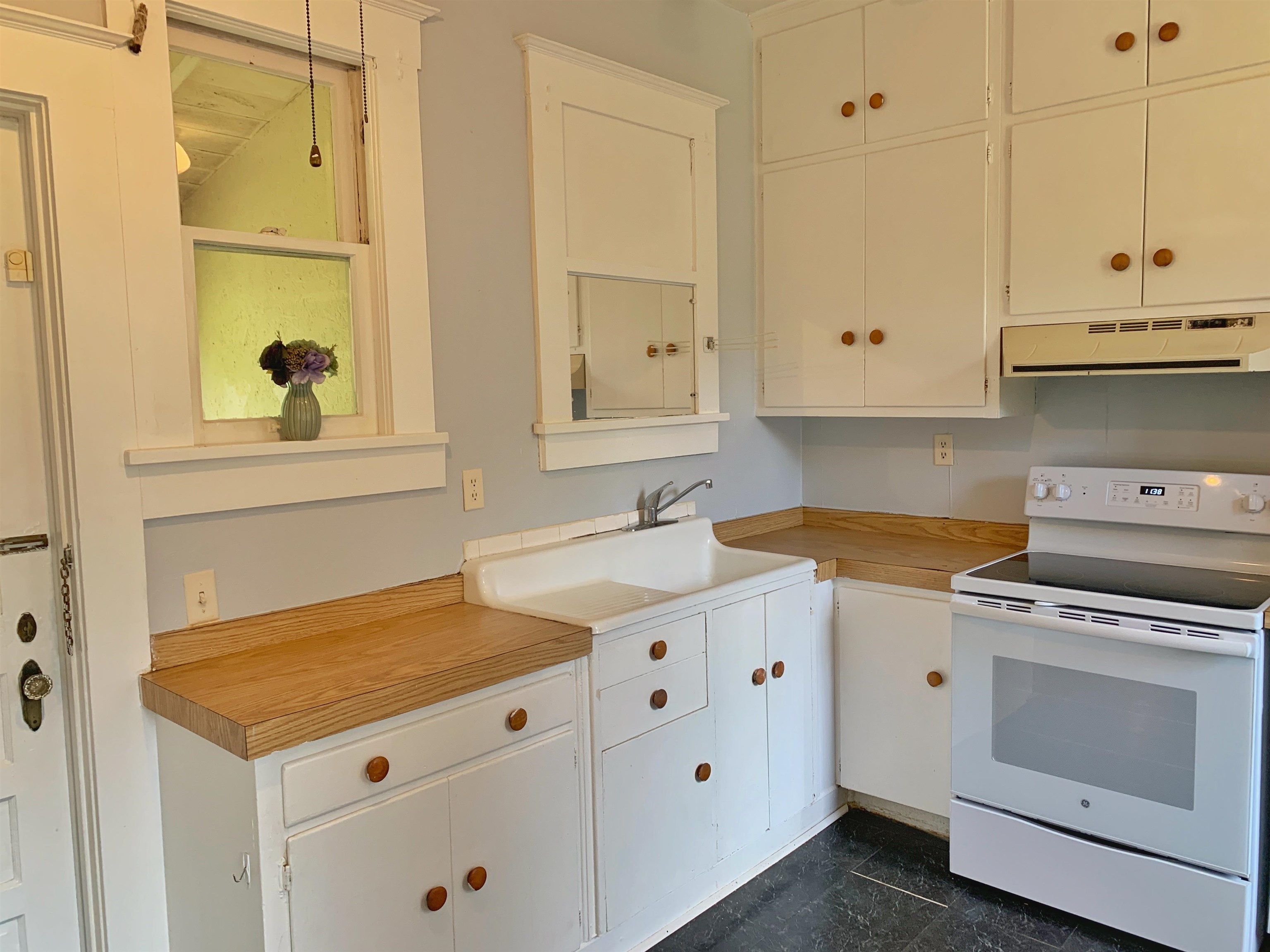 142 Oviedo Street St. Augustine, FL 32084 - Photo 7 of 15 a kitchen with granite countertop a stove sink and cabinets