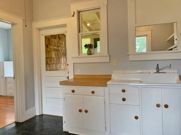 a bathroom with a sink vanity and mirror