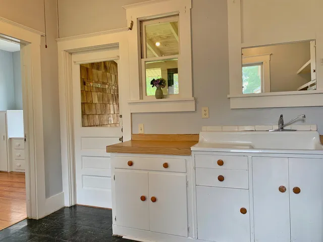 a bathroom with a sink vanity and mirror