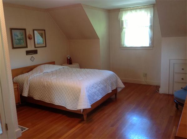 78 Richfield Road Arlington, MA 02474 - Photo 25 of 30 a bedroom with a bed and wooden floor