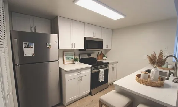 a kitchen with a sink appliances and cabinets