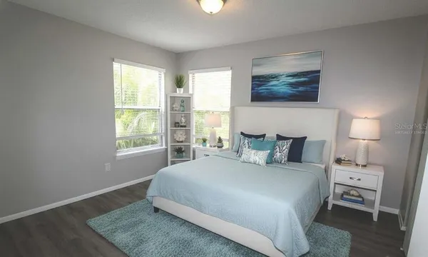 a large bed sitting in a bedroom next to a window