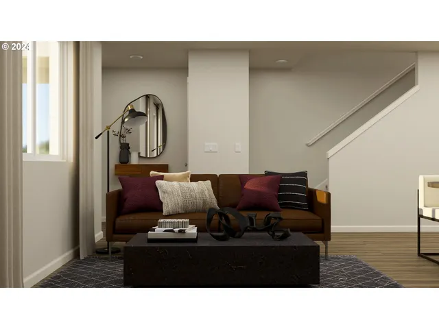 a living room with furniture a flat screen tv and kitchen view